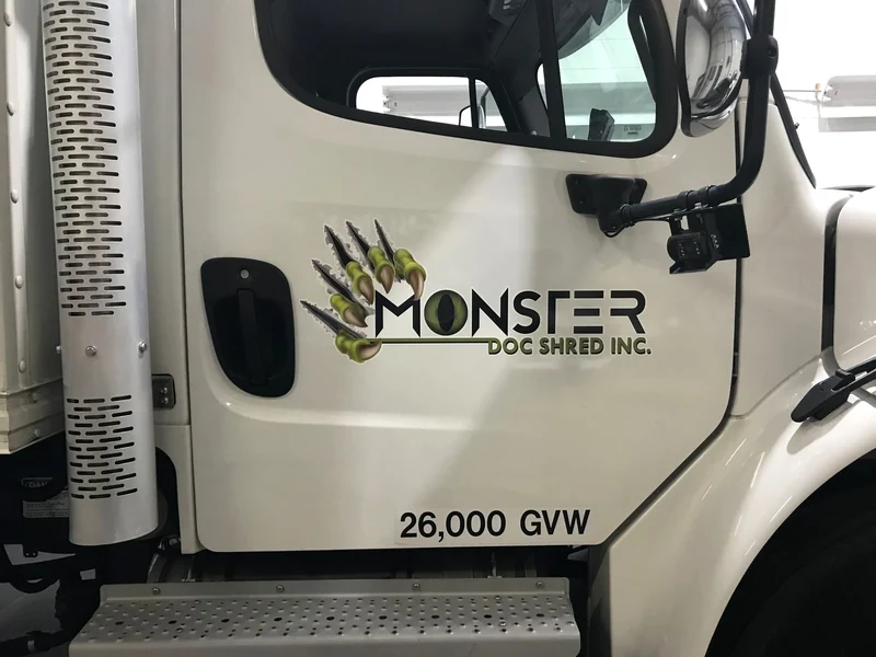 The cab of a Monster Doc Shred box truck carrying its claw mark