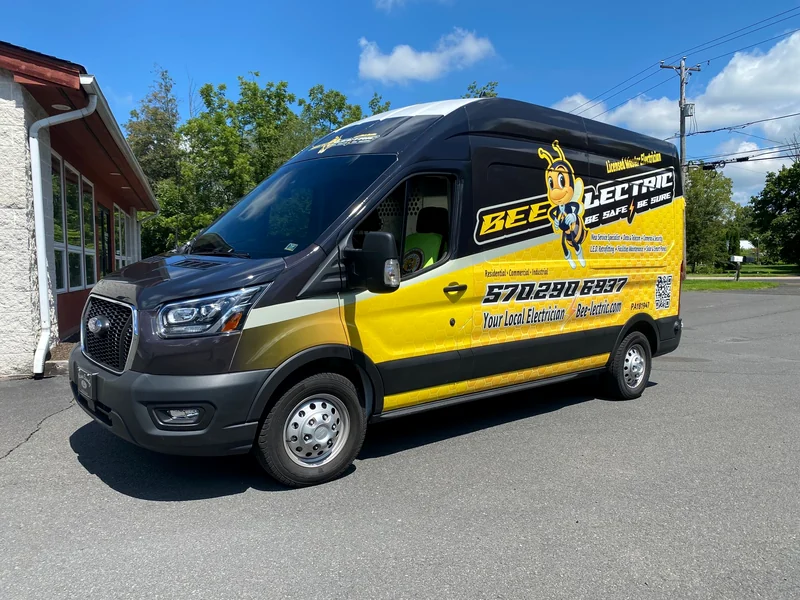 A Bee-lectric electrician's van in black and yellow